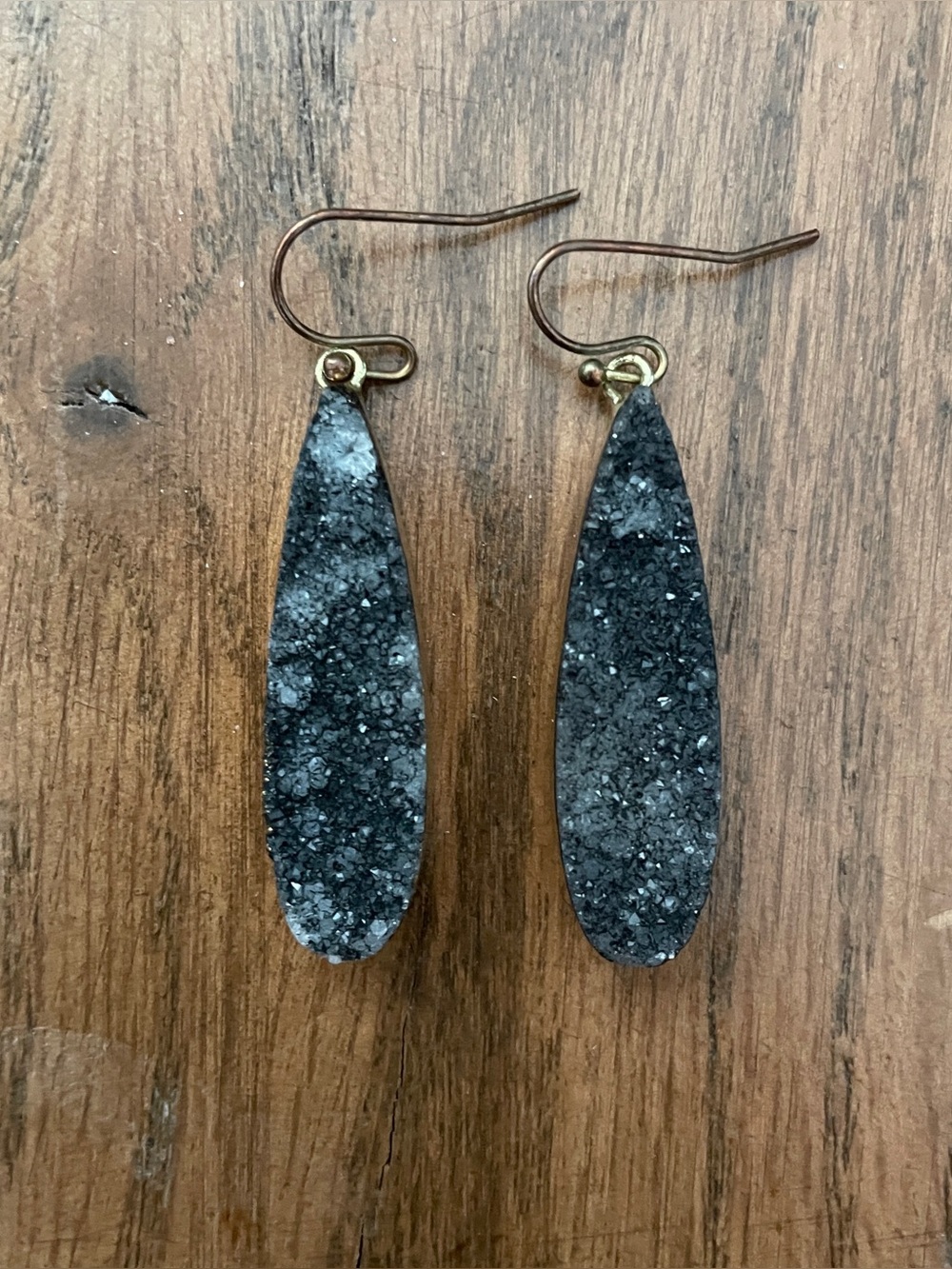 Unique gray/black sparkly stone earrings with gold tone casing and gold plated